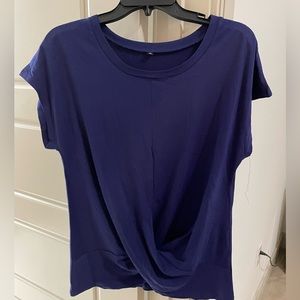 Purple T-shirt that twists in the front.